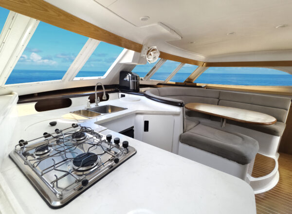 cozy living room kitchen featuring stylish curved couch table located sailing boat 3
